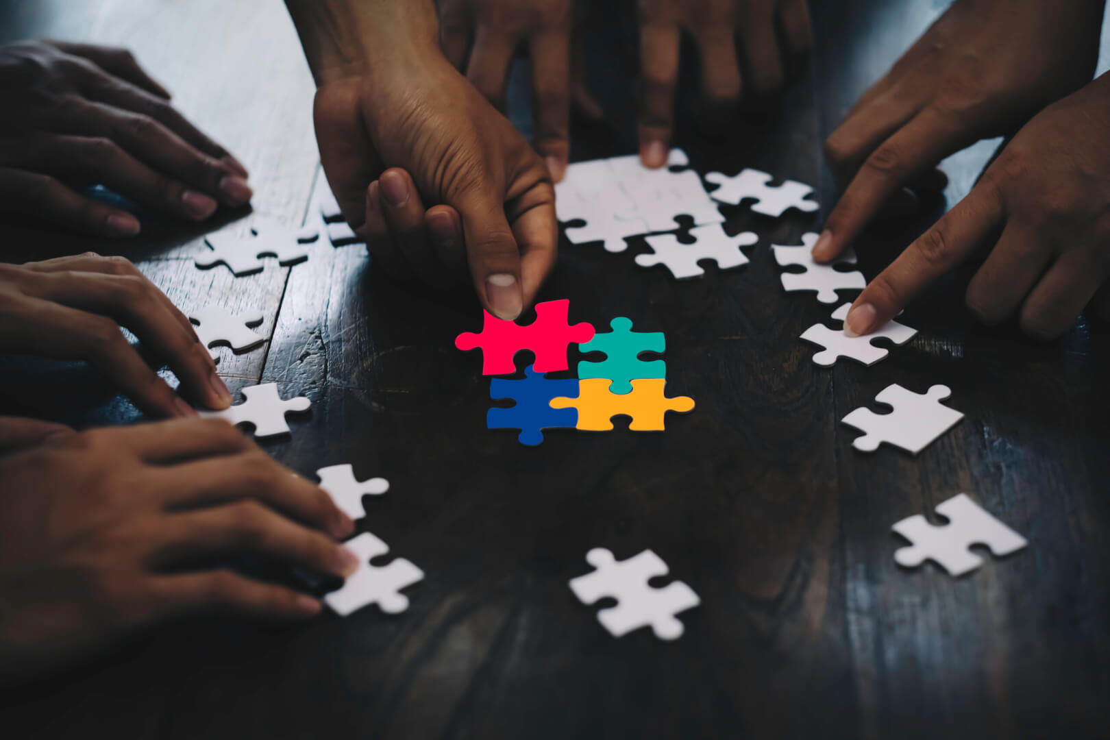 Closeup hand of business people connecting jigsaw puzzle with sunlight effect, Business solutions and represent team support and help concept, success and strategy concept